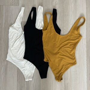 Wild Honey Bodysuits in White, Black, and Mustard